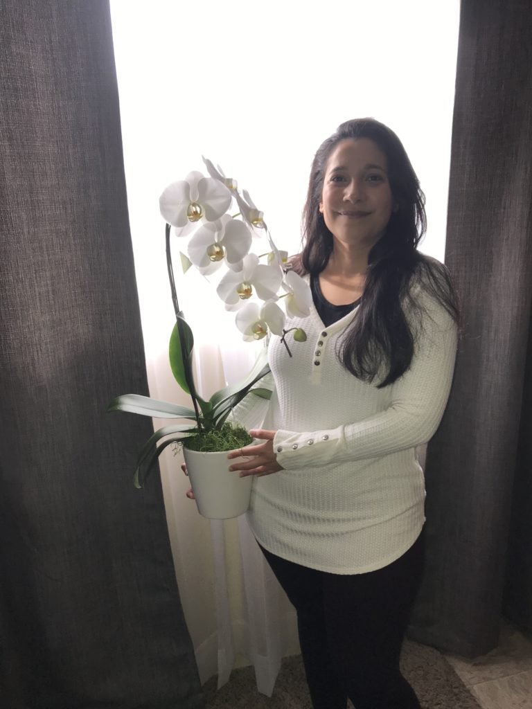 Woman Holding Orchids.