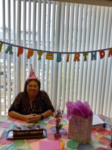 Women sitting with a birthday cake